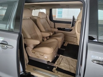 kia carnival for rent in bangalore airport side view